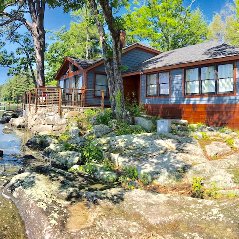 Exterior home with fresh paint surrounded by trees